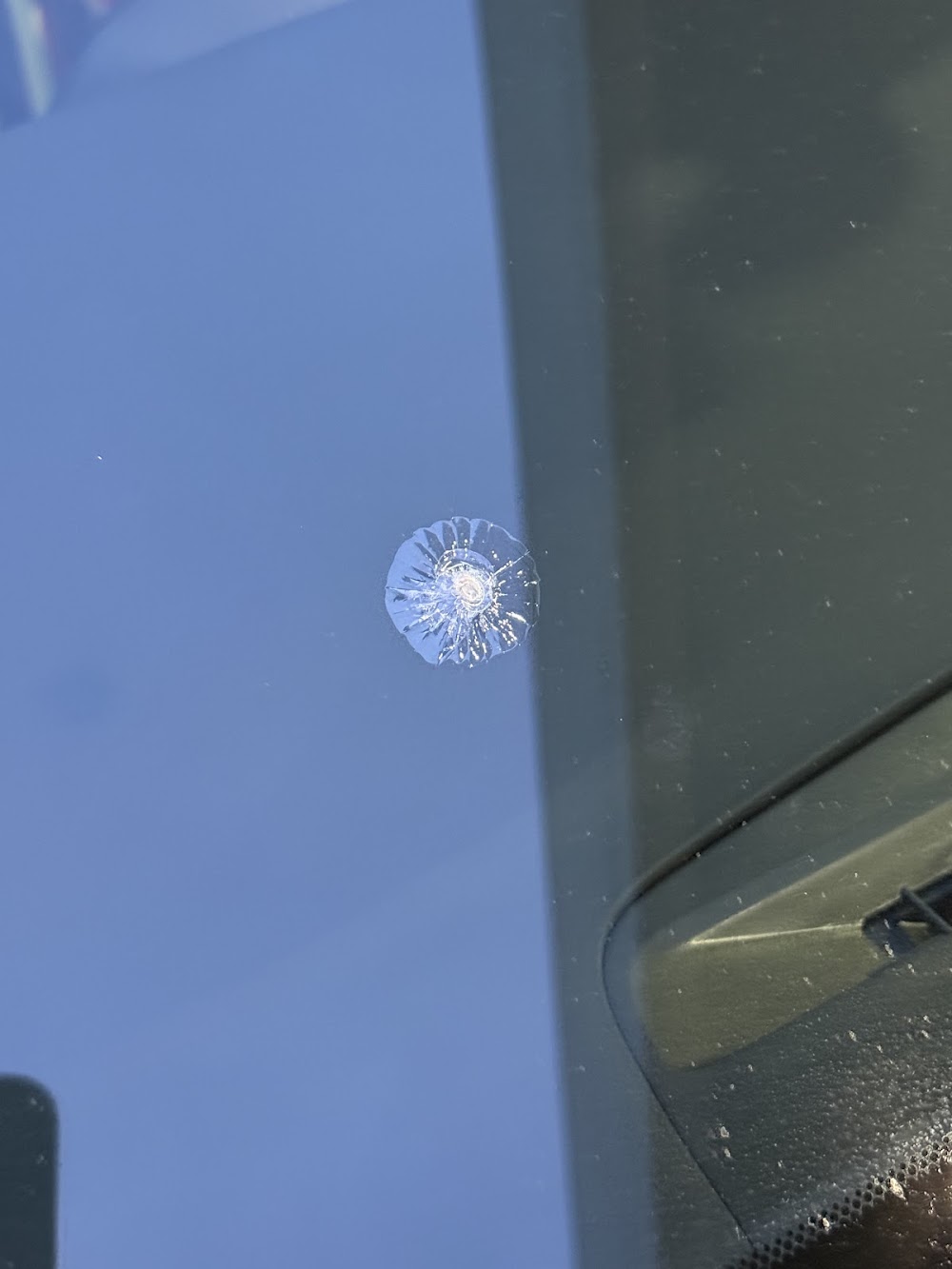 A rock chip in a windshield before chip repair at Epic Glass Tinting