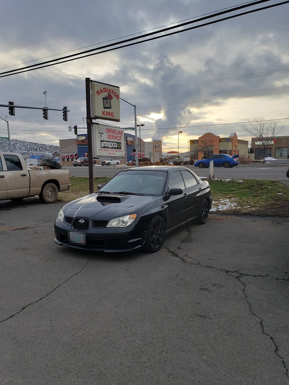 A black Subaru with freshly tinted windows after a tint install at Epic Glass Tinting
