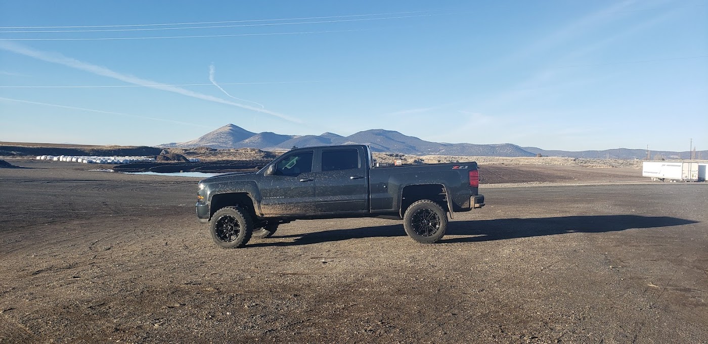 A lifted gray Chevy Silverado with tinted windows in the Klamath Basin